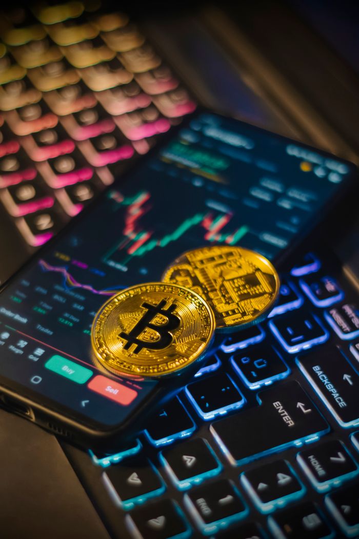 gallery-06 Colorful keyboard with Bitcoin coins and trading screen for crypto analysis.