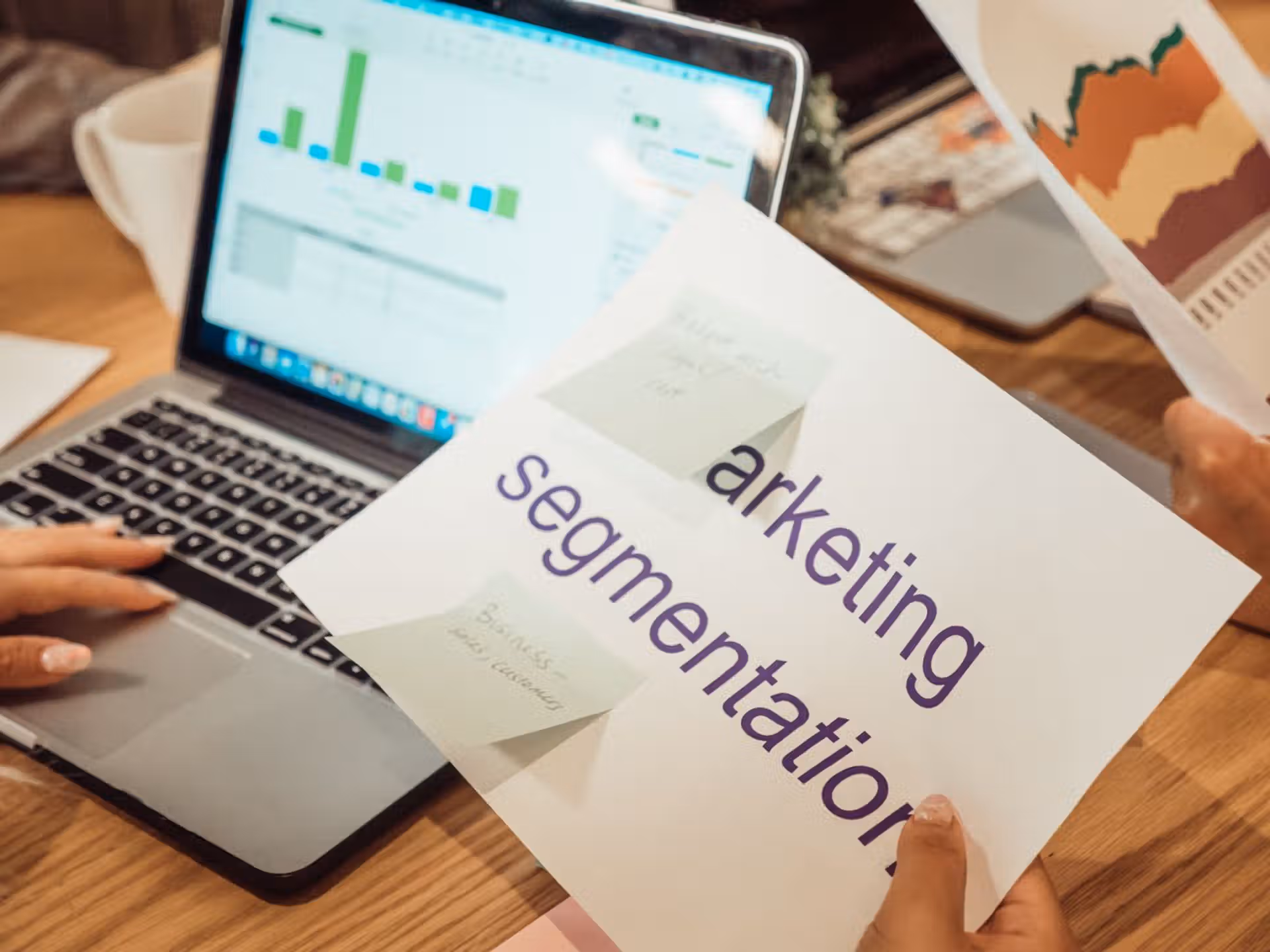 Crafting Captivating Headlines: Your awesome post title goes here A modern workspace showing hands analyzing marketing data on a laptop and paper documents.